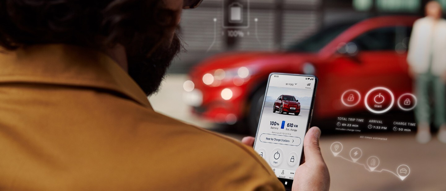 Man holding mobile with FordPass app